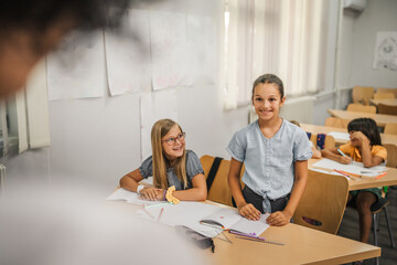 Fototapeta premium young caucasian girl stand and answer question of teacher
