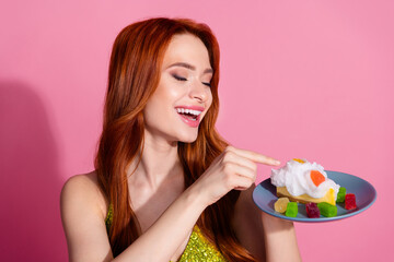 Photo of pretty young woman touch creamy cake wear shiny top isolated on pink color background