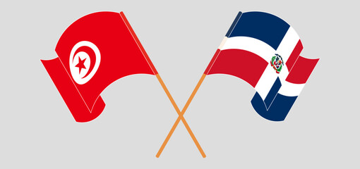 Crossed and waving flags of Tunisia and Dominican Republic