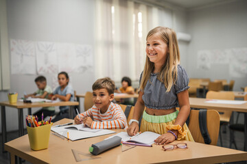 Fototapeta premium young caucasian girl stand and answer question of teacher