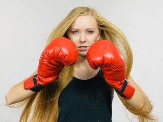 Woman in gloves playing sports boxing