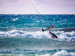 Fototapeta premium Kite surfer in sea waves. Kiteboarding sport.