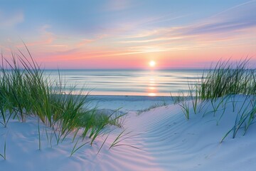 A serene beach scene at sunset, with soft sand dunes and tall grasses in the foreground, leading to an unobstructed view of calm waters meeting the horizon under a pastel sky. The sun casts long shado