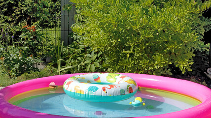 Inflatable pool in summer with swimming lap. Children and water games. Summer fun. 