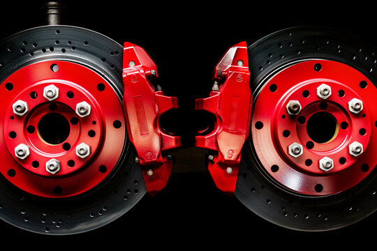 Brake discs and red calipers of a racing car on a black background