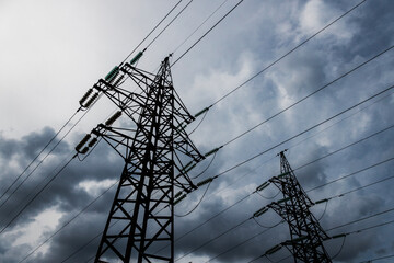 Power lines pierce dramatic cloudy skies