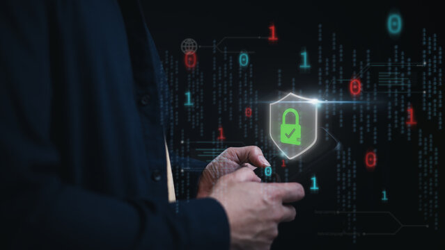 Man holding smartphone with a green lock and check mark inside shield on screen in digital binary code background. Concept of cyber security and protection against potential threats - Powered by Adobe