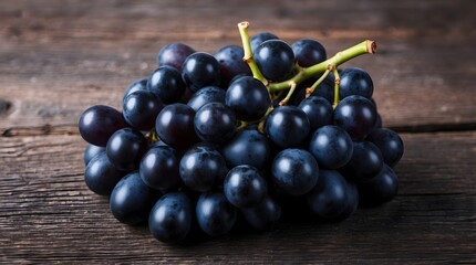 Fototapeta premium concept photo of a black grape on wooden background