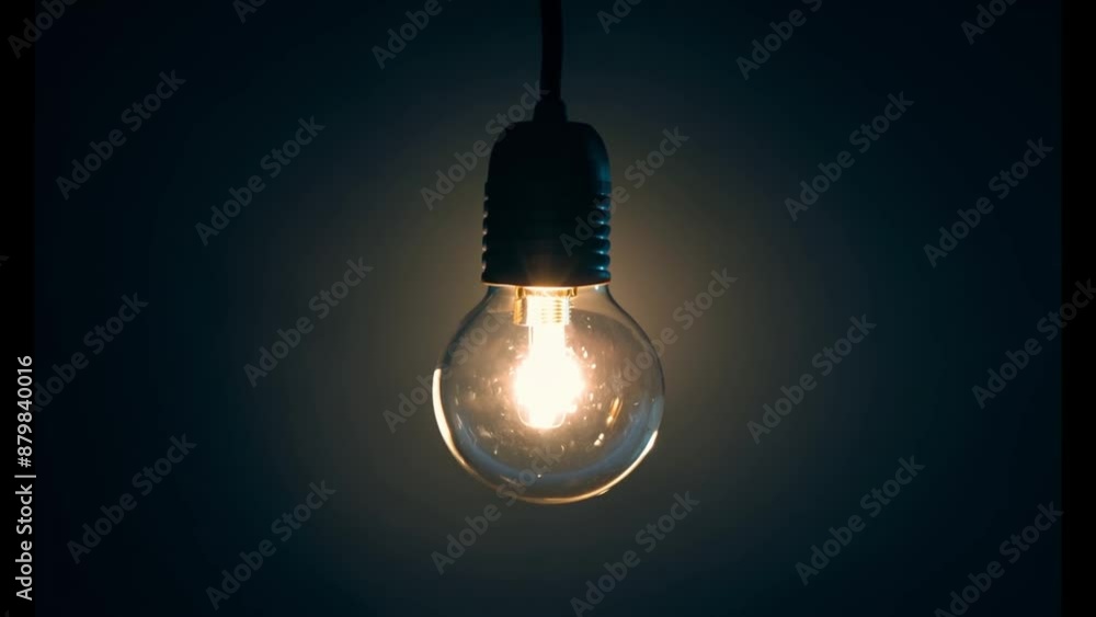 Poster a single light bulb is illuminated in the center of a dark room, casting a soft, warm glow and creat
