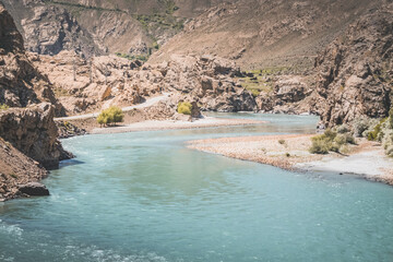 The Panj River flows between Afghanistan and Tajikistan along the Pamir Highway road in the Tien Shan mountains