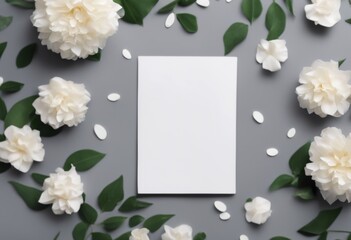 white background blank grey card top flowers near green leaves paper view
