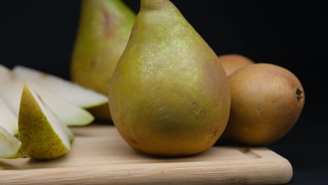 a green pear on a dark background