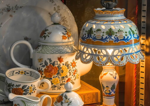 A cozy composition of an antique lamp, a kettle and a dish