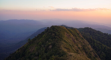 Mountain bathed in golden light at sunset.