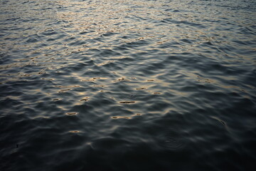 Dark blue water with sunlight reflecting on the surface.