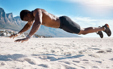 Black man, topless and plank for workout or cardio on beach as athlete in summer for morning exercise. Strong, African and male person in mid air for sports or training in USA for fitness or muscle