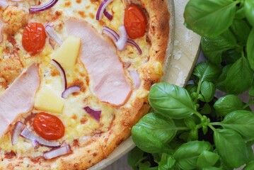 Whole Homemade Pizza with Ham on Wooden Table with Ingredients Background. National Pizza Day, La Giornata Mondiale della Pizza, World Pizza Day. Tasty, Food, Fast Food, Hunger.