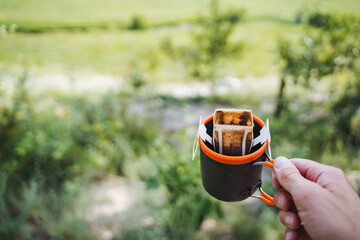 Transform your outdoor coffee routine with a convenient portable drip coffee maker amidst the beauty of nature, adding a touch of luxury to your wilderness relaxation