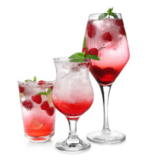 Glasses of fresh raspberry mojito on white background