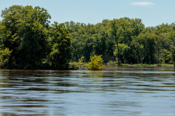 Very fast moving Wisconsin River, flows past a flooded island, flooded from recent rains in July,...