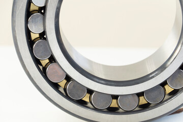 Metal ball bearing  on a white background. Friction bearing.  Spare parts for roller machine in heavy machinery and automotive industry