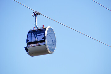 Cable car cabin against the sky. A modern glass cable car cabin at a ski resort.