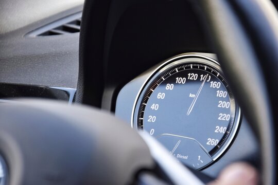 The speedometer of a modern car shows a high driving speed.