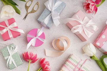 Gift boxes and beautiful tulips on white background