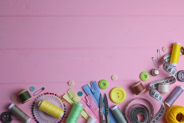 A wide range of sewing materials and tools is located on a colored background