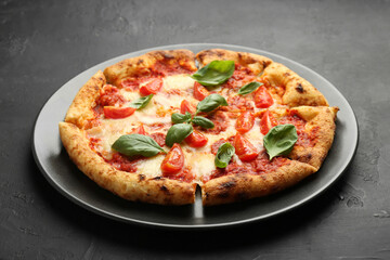 One delicious Margherita pizza on black table