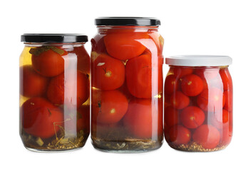 Tasty pickled tomatoes in jars isolated on white
