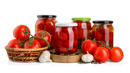 Tasty pickled tomatoes in jars, spices and vegetables isolated on white