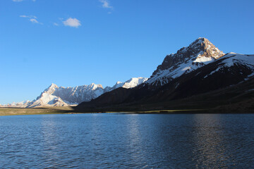 Pamir , Shimshal Pass lake and you can see mountains in background .