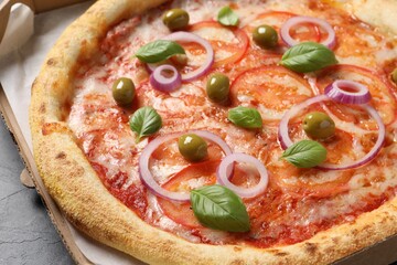 Delicious vegetarian pizza in box on black table, closeup
