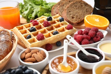 Different meals served for breakfast on white table, closeup. Buffet menu