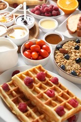 Different meals served for breakfast on white table, closeup. Buffet menu