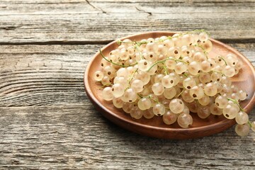 Fresh white currant berries on wooden table, closeup