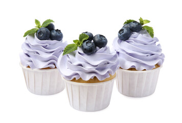 Tasty cupcakes with blueberries and mint isolated on white