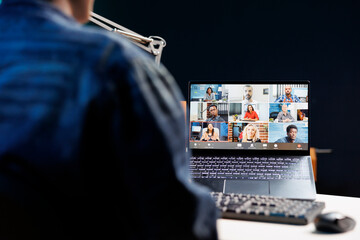 Engaged group of individuals, including African American person, utilizing technology for virtual communication. They are working remotely, attending online meetings or classes in a cozy home office.