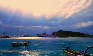 Boats in harbor with rays of sun nautical background