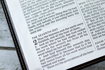 Seventh Day (Christian Sabbath) verses in open holy bible book. Biblical concept of rest, blessing,...