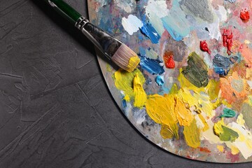 Obraz premium Artist's palette, brush and paints on grey table, top view. Space for text