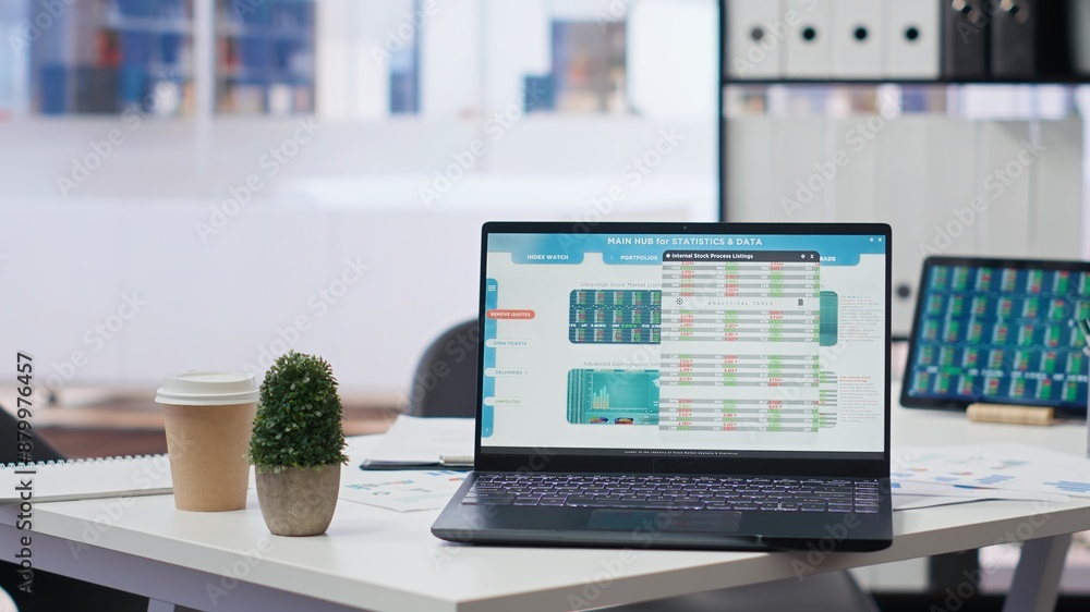 Poster financial analyst workplace featuring laptop and tablet displaying stock exchange data and statistic