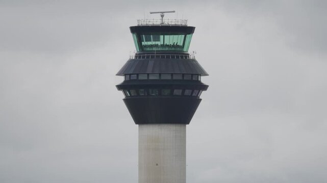 Close up of Air Traffic Control tower with clouds in background