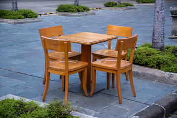 Wooden brown table chairs in the public park