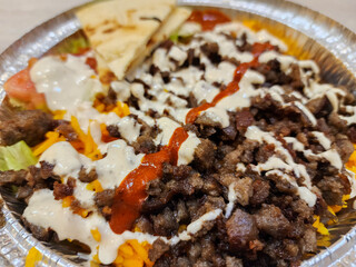 Delicious basmati rice with beef grilled, salad, chili sauce, and mayonnaise 