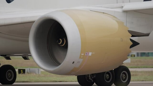 Close up of jet engine starting up on modern aircraft before take-off