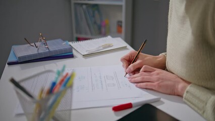 Unknown teacher checking homework at office desk closeup. Woman putting marks