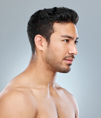 Obraz premium Man, thinking and profile for skincare in studio with grooming, wellness and pride for glow. Male model, dermatology and idea for luxury treatment, shine and routine for clean face by gray background