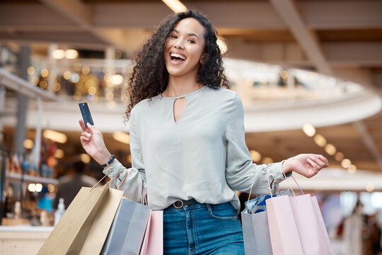 Happy woman, portrait and shopping bags with credit card at mall for payment, swipe or spend money. Young female person or shopper with smile or debit for fashion, online transaction or buying spree